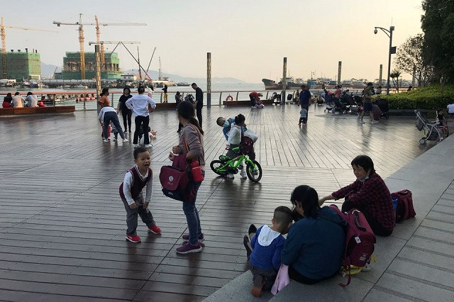 children play at a waterfront in shekou area of shenzhen guangdong province china march 15 2021 photo reuters