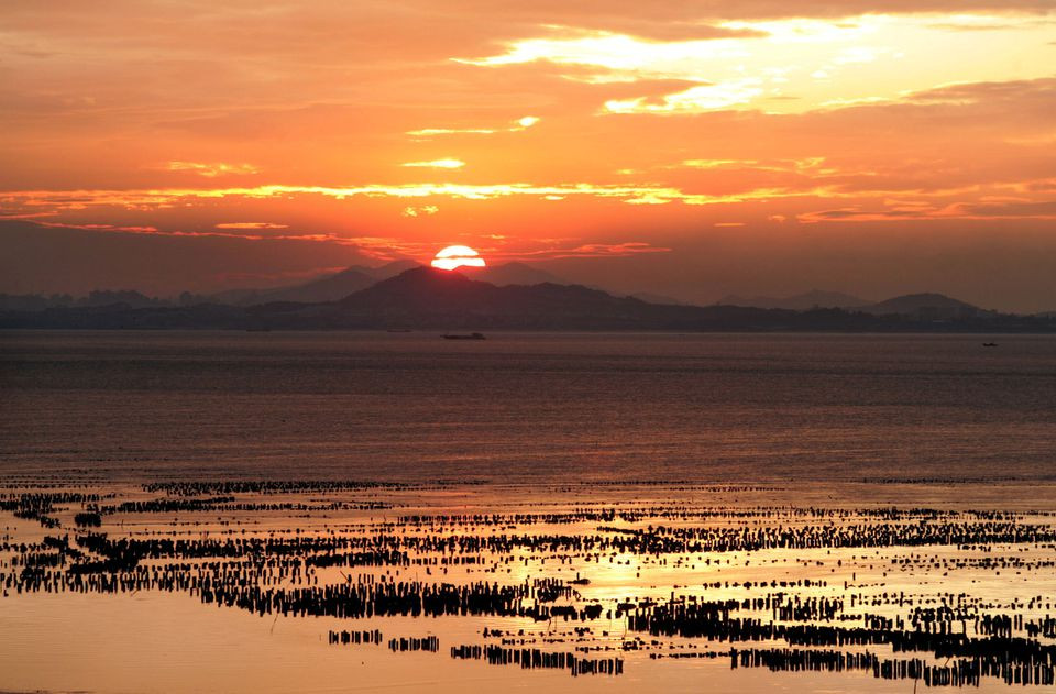 the sun sets over china s southeastern coast of fujian as seen from taiwan s frontline island of kinmen on september 11 2004 photo reuters