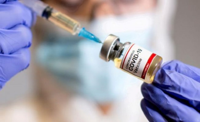 a woman holds a small bottle labelled with a coronavirus covid 19 vaccine sticker and a medical syringe in this illustration taken october 30 2020 photo reuters file a woman holds a small bottle labelled with a coronavirus covid 19 vaccine sticker and a medical syringe in this illustration taken october 30 2020 photo reuters file