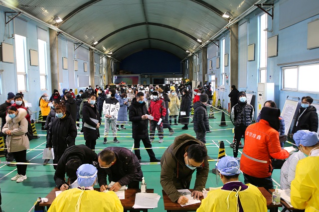 people line up to receive the vaccine against covid 19 at a makeshift vaccination site inside a sports centre in beijing s haidian district china january 8 2021 photo reuters