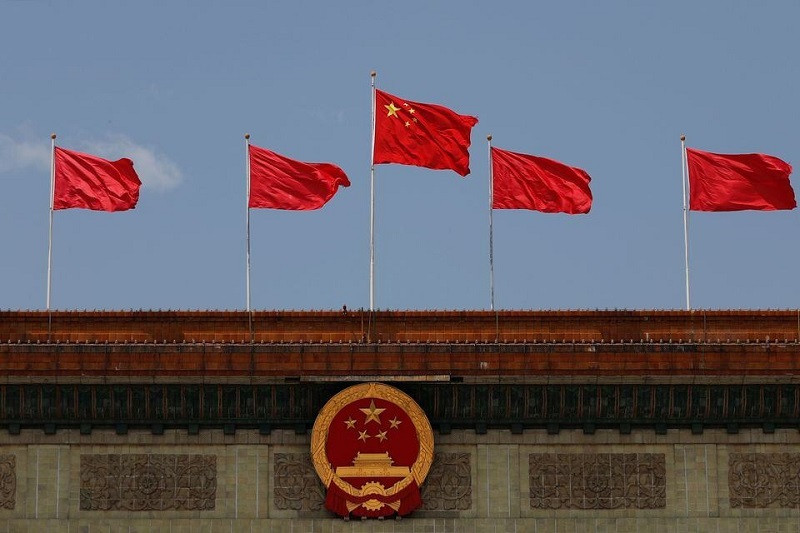chinese flag flutters above the chinese national emblem at the great hall of the people in beijing china may 22 2020 photo reuters