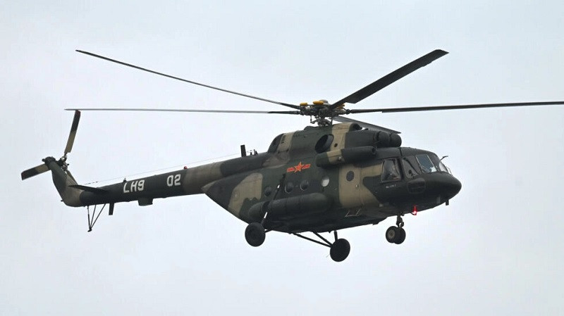 a chinese military helicopter flies over pingtan island the closest point to taiwan on april 7 2023 photo afp