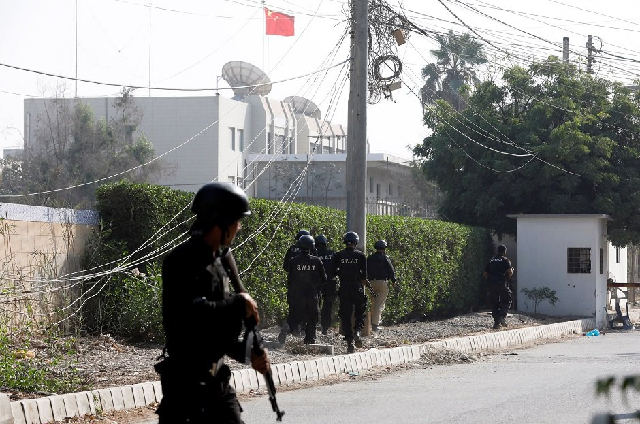 police officers take cover as they move during an attack on the chinese consulate photo reuters file