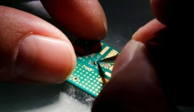 a researcher plants a semiconductor on an interface board during a research work to design and develop a semiconductor product at tsinghua unigroup research centre in beijing china february 29 2016 photo reuters