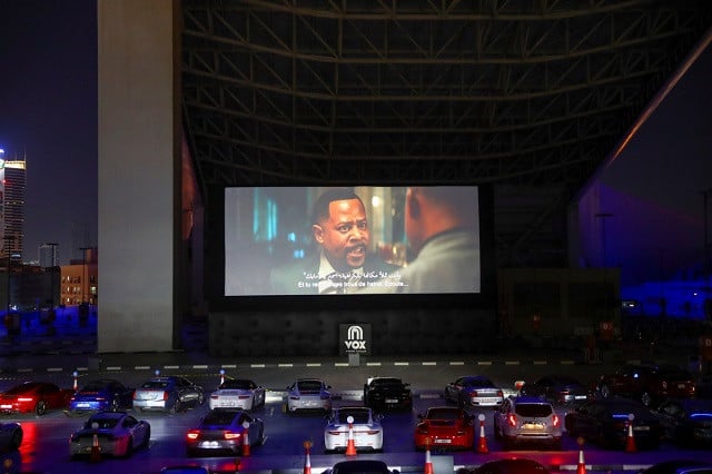 people sit in their cars watching a movie in a drive in cinema at the mall of the emirates following the outbreak of the coronavirus disease covid 19 in dubai united arab emirates on may 13 2020 photo reuters