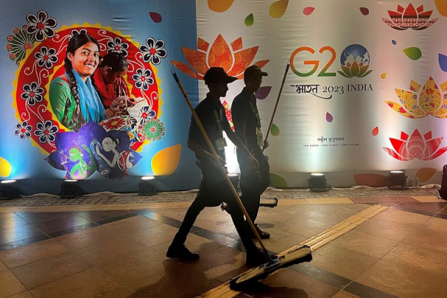 cleaners walk past a hoarding at the international media center during the g20 summit in new delhi india september 9 2023 photo reuters cleaners walk past a hoarding at the international media center during the g20 summit in new delhi india september 9 2023 photo reuters