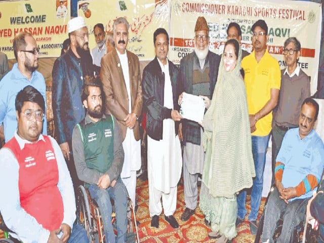 commissioner karachi syed hasan naqvi presents a certificate on behalf of kba to poa s associate secretary tehmina asif for her services for sports photo app