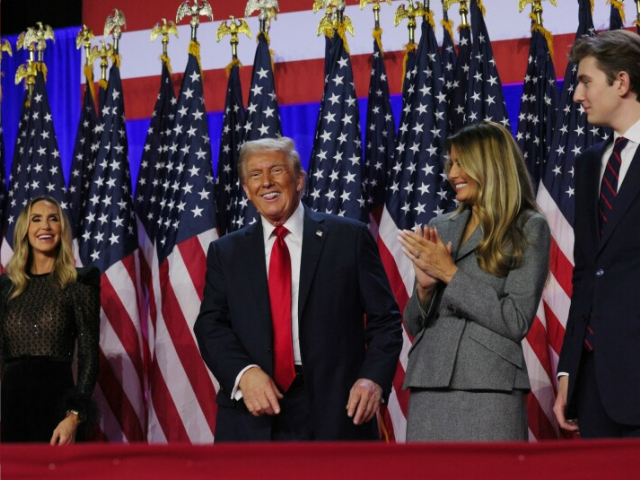 republican presidential nominee and former u s president donald trump smiles while accompanied by his wife melania lara trump and son barron at his rally at the palm beach county convention center in west palm beach florida u s november 6 reuters