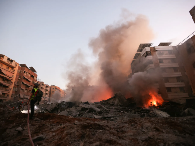 a rescuer fights the blaze amid the smoldering rubble of a building destroyed in an israeli airstrike in beirut s southern suburbs on september 27 2024 photo by afp ibrahim amro