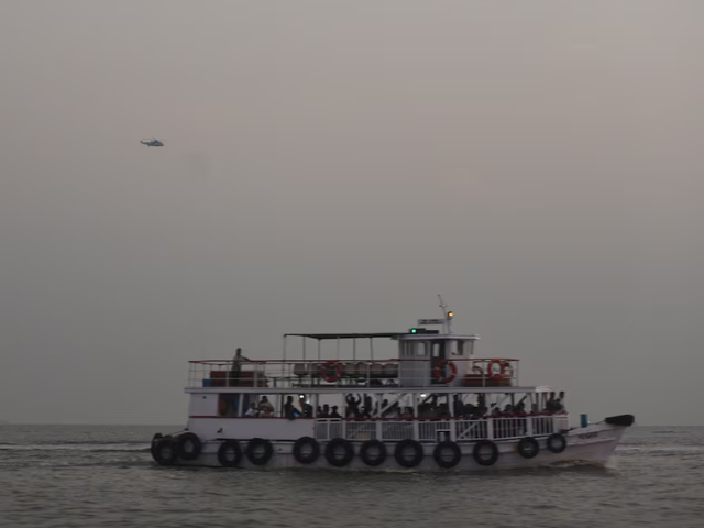 a military helicopter flies over a ferry during a rescue operation after a passenger boat capsized off the coast of india s financial capital mumbai india december 18 2024 reuters