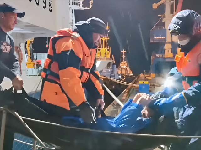 rescuers leave a vessel while carrying a man who was reportedly saved after his sailboat had drifted for 67 days in waters edging the northwestern pacific and discovered by fishermen in the sea of okhotsk though his brother and nephew had died during the ordeal upon their arrival in the port city of magadan russia in this still image taken from video released on october 15 2024 russian emergencies ministry handout via reuters