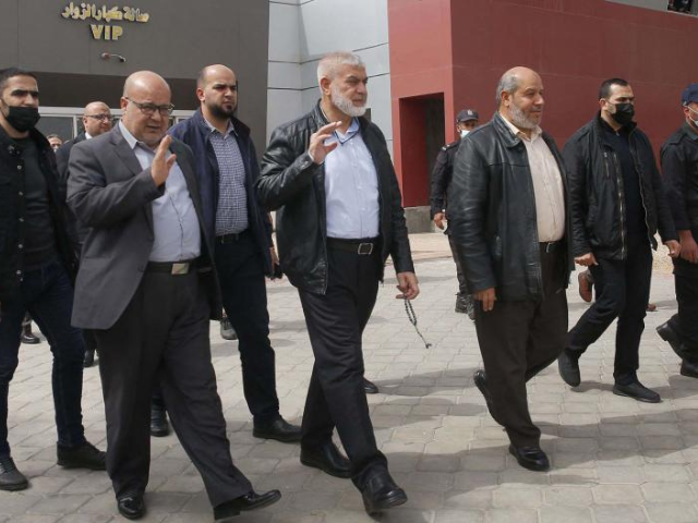 hamas leaders essam aldalis ruwhi mushtaha and khalil al hayya walk outside the vip hall at the rafah border crossing with egypt in the southern gaza strip on march 15 2021 afp