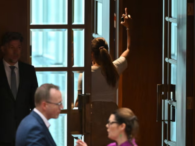 Lidia Thorpe gestures as she walks away after throwing papers at Pauline Hanson. Photograph: Mick Tsikas/AAP