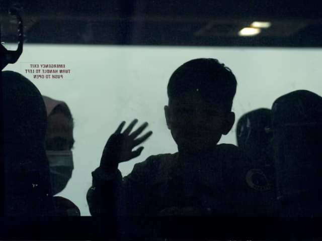 a day after u s forces completed their troop withdrawal from afghanistan an afghan boy waves from a bus taking refugees to a processing center upon their arrival at dulles international airport in dulles virginia u s september 1 2021 reuters kevin lamarque file photo