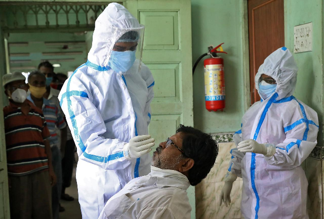 a healthcare worker wearing personal protective equipment ppe takes a swab from a man for a rapid antigen test as others wait for their turn at a check up centre amidst the spread of the covid 19 in kolkata india photo reuters file a healthcare worker wearing personal protective equipment ppe takes a swab from a man for a rapid antigen test as others wait for their turn at a check up centre amidst the spread of the covid 19 in kolkata india photo reuters file