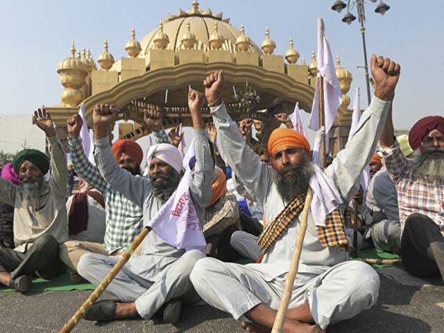 farmers shout slogans as they block a road during a protest photo afp