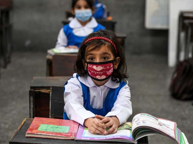 children attend a class at a school in islamabad photo afp