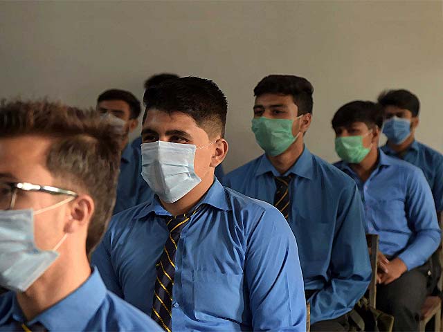 students attend a class at a school in peshawar photo afp