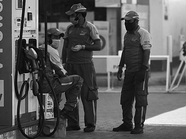 petrol station workers wearing face masks wait for customers photo afp