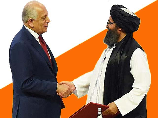 zalmay khalilzad and taliban co founder mullah abdul ghani baradar shake hands photo afp