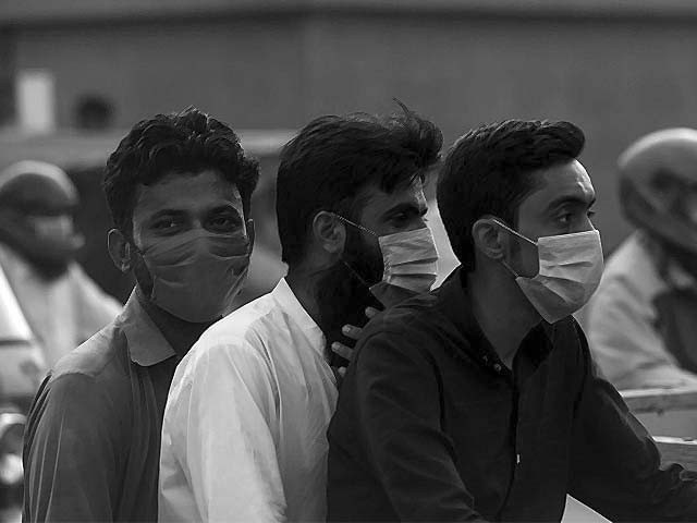 commuters wearing face masks ride on a bike photo afp