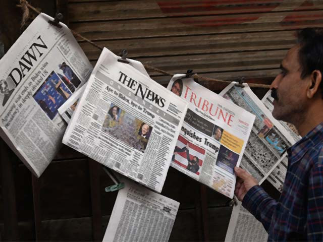a man at a newspaper stall in lahore photo afp