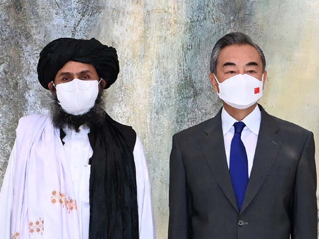 chinese foreign minister wang yi meets with mullah abdul ghani baradar political chief of afghanistan s taliban photo afp