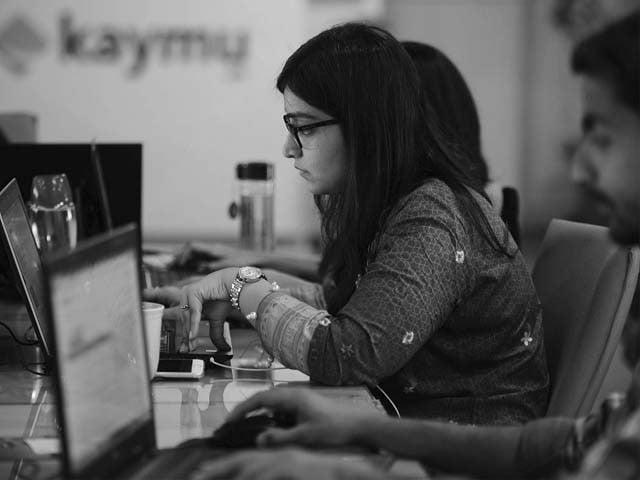 a woman works at her laptop photo afp