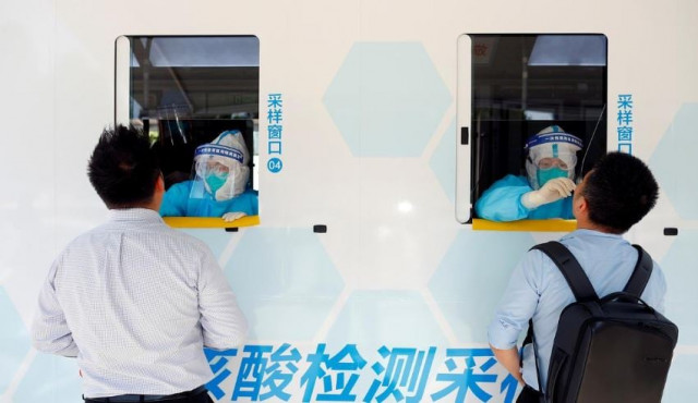 two people are tested at the windows of a testing vehicle following a new outbreak of the coronavirus disease covid 19 in beijing china photo reuters two people are tested at the windows of a testing vehicle following a new outbreak of the coronavirus disease covid 19 in beijing china photo reuters