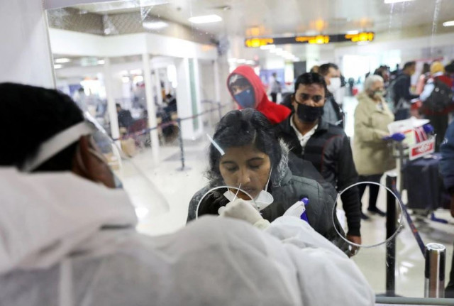 a healthcare worker collects a coronavirus disease covid 19 test swab sample from a woman at the indira gandhi international airport in new delhi india december 3 2021 photo reuters file a healthcare worker collects a coronavirus disease covid 19 test swab sample from a woman at the indira gandhi international airport in new delhi india december 3 2021 photo reuters file
