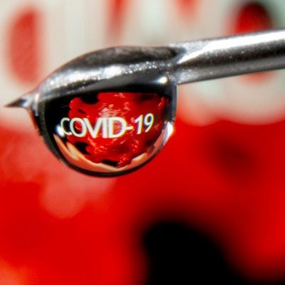 the word covid 19 is reflected in a drop on a syringe needle in this illustration taken november 9 2020 photo reuters