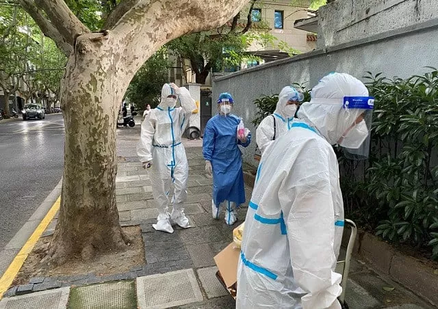 workers in protective suits walk on a street following the coronavirus disease covid 19 outbreak in shanghai china june 9 2022 photo reuters workers in protective suits walk on a street following the coronavirus disease covid 19 outbreak in shanghai china june 9 2022 photo reuters