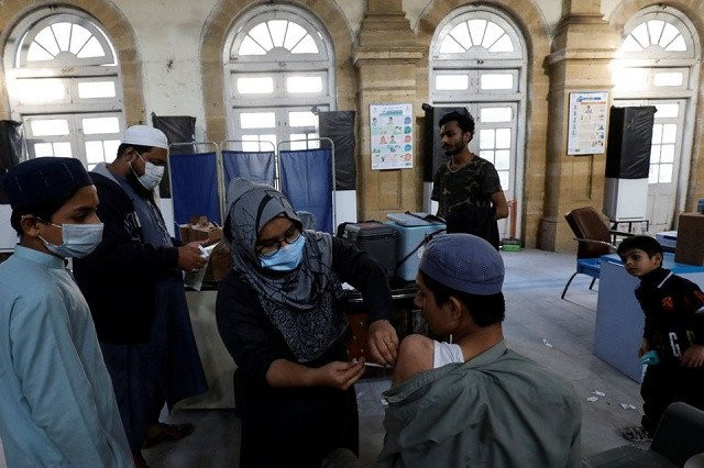 a healthcare worker administers a dose of coronavirus disease covid 19 vaccine at a vaccination centre in karachi pakistan january 16 2022 photo reuters file