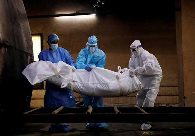 a health worker and relatives wearing personal protective equipment ppe carry the body of a man who died due to the coronavirus for his cremation in new delhi photo reuters file