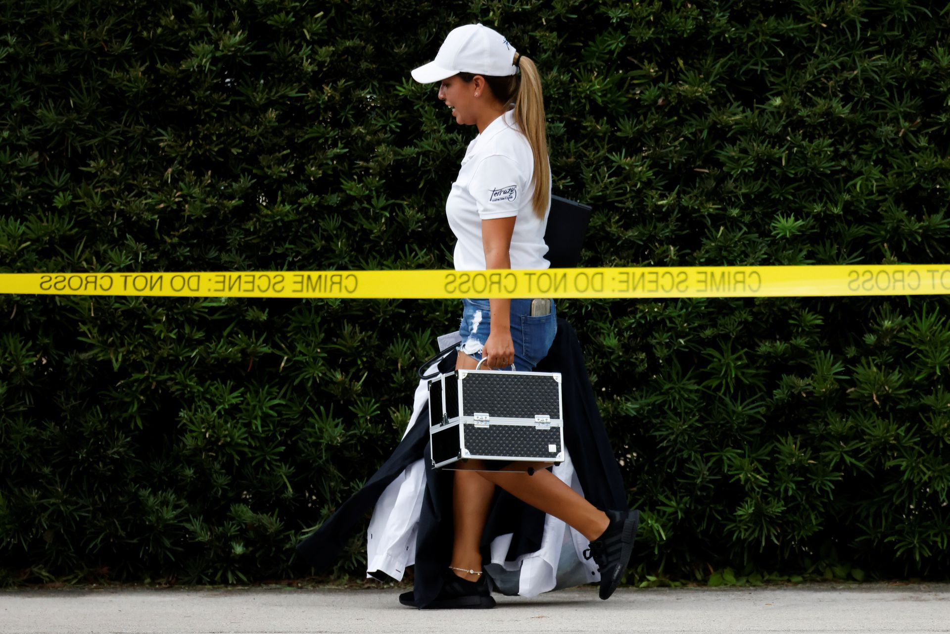 a woman walks out of the crestview towers condominium after the city of north miami beach ordered the evacuation of the building deeming it unsafe in north miami beach florida us photo reuters