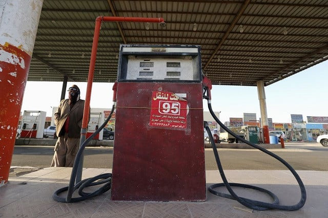 a fuel pump assistant stands next to an old fuel pump during the early hours near the village of salwa at the qatari saudi border south of the eastern province of khobar saudi arabia january 29 2016 photo reuters a fuel pump assistant stands next to an old fuel pump during the early hours near the village of salwa at the qatari saudi border south of the eastern province of khobar saudi arabia january 29 2016 photo reuters