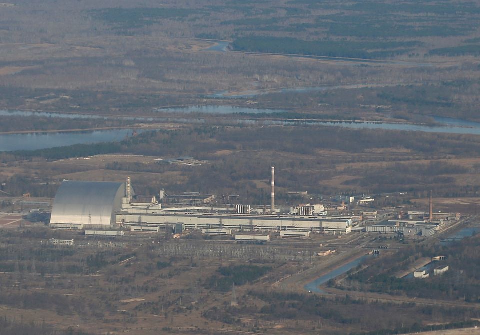 an aerial view from a plane shows a new safe confinement nsc structure over the old sarcophagus covering the damaged fourth reactor at the chernobyl nuclear power plant during a tour to the chernobyl exclusion zone ukraine april 3 2021 photo reuters