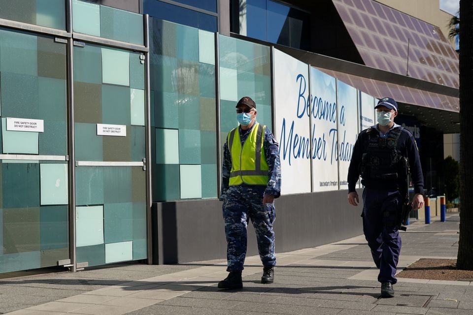 personnel from the australian defence force and new south wales police force patrol a street in the bankstown suburb during an extended lockdown to curb the spread of the coronavirus disease covid 19 in sydney australia august 3 2021 photo reuters