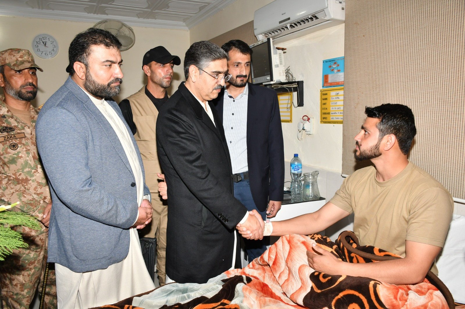 prime minister anwaarul haq kakar shakes hands with a soldier injured in the terrorist attack in di khan on december 13 2023 photo app
