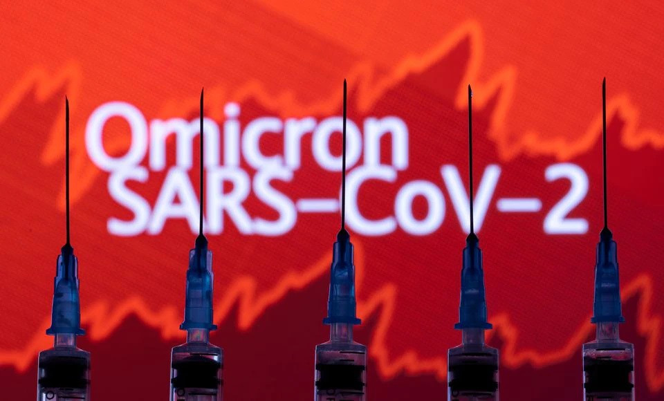 syringes with needles are seen in front of a displayed stock graph and words omicron sars cov 2 in this illustration taken november 27 2021 photo reuters