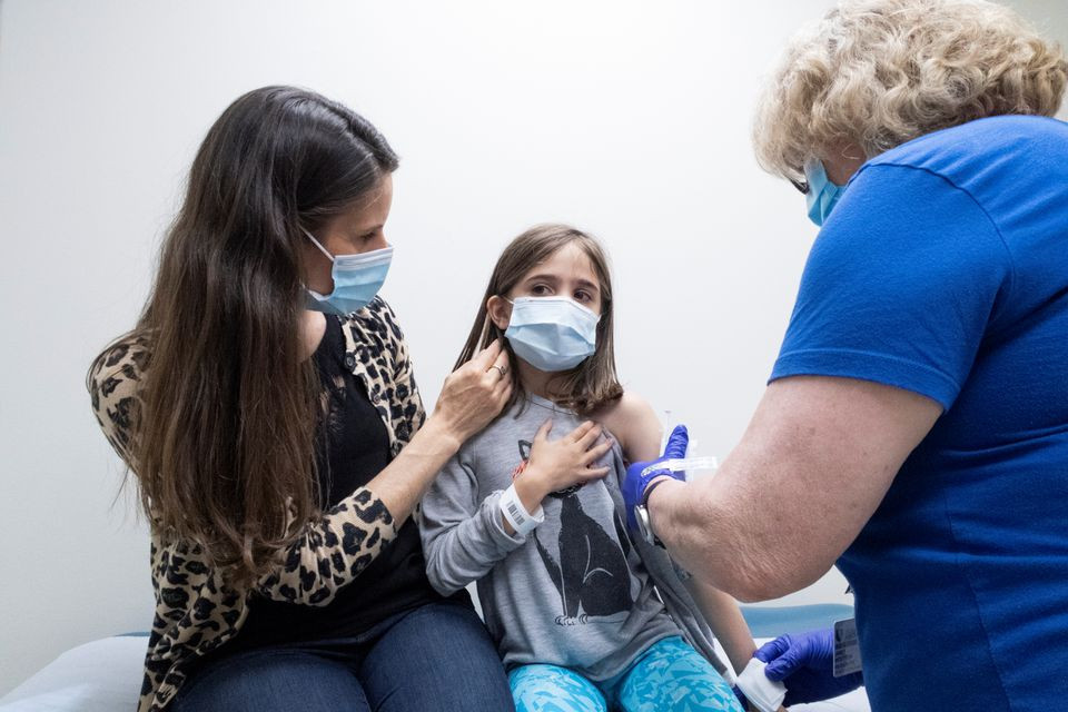 marisol gerardo 9 is held by her mother as she gets the second dose of the pfizer coronavirus disease covid 19 vaccine during a clinical trial for children at duke health in durham north carolina us photo reuters