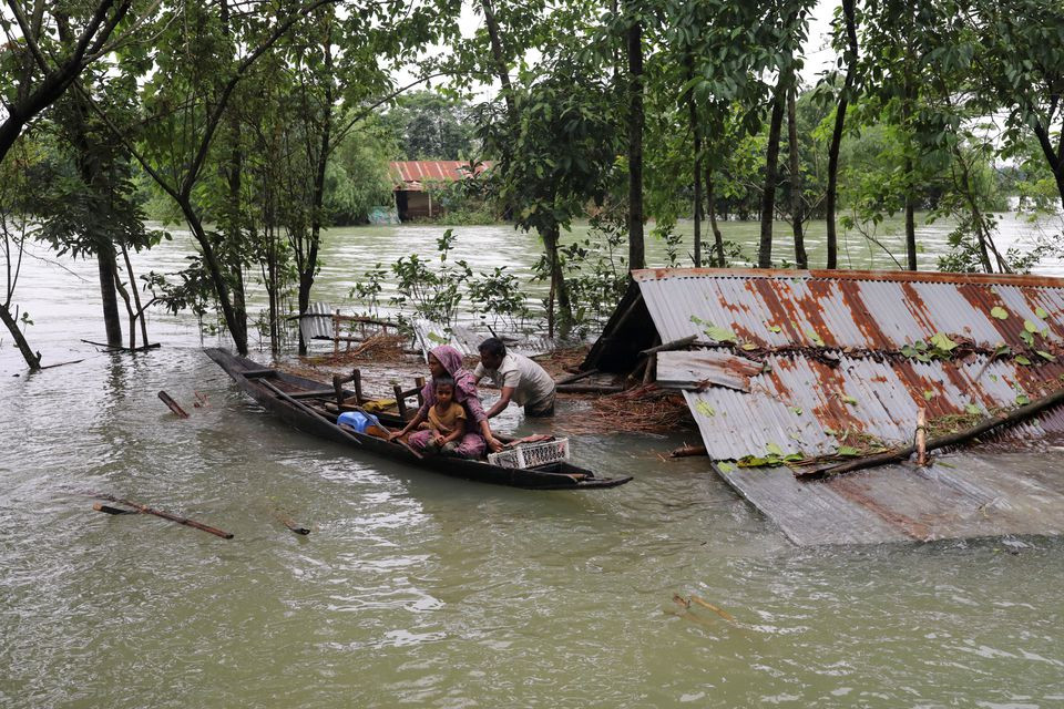 People get on a boat as they look for shelter during a widespread flood in the northeastern part of the country, in Sylhet, Bangladesh, June 19, 2022. REUTERS