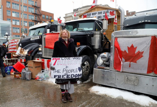 a person hold a sign as truckers and supporters continue to protest coronavirus disease covid 19 vaccine mandates in ottawa ontario canada february 3 2022 photo reuters a person hold a sign as truckers and supporters continue to protest coronavirus disease covid 19 vaccine mandates in ottawa ontario canada february 3 2022 photo reuters