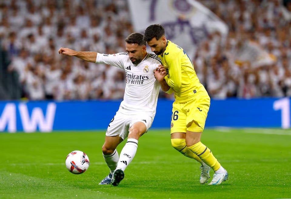 real madrid s dani carvajal in action with villarreal s alex baena during laliga s match between real madrid vs villarreal at santiago bernabeu madrid spain on october 5 2024 photo reuters