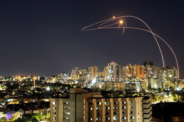 Streaks of light are seen as Israel's Iron Dome anti-missile system intercepts rockets launched from the Gaza Strip towards Israel, as seen from Ashkelon, Israel May 14, 2021. PHOTO: REUTERS