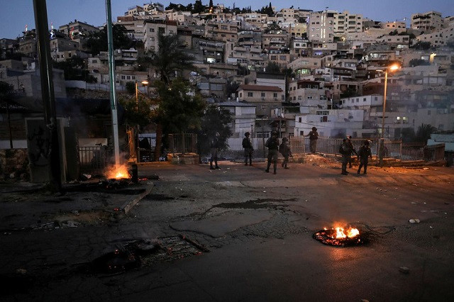 Israeli Border police force members stand guard on a street during clashes with Palestinians in East Jerusalem May 14, 2021. PHOTO: REUTERS