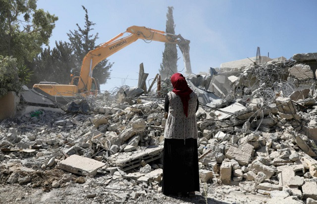 fawzia stands on the ruins of her house after her palestinian ex husband demolished the dwelling to not face the prospect of israeli settlers moving in after he lost a land ownership case in israeli courts in the east jerusalem neighbourhood of beit hanina july 19 2018 photo reuters