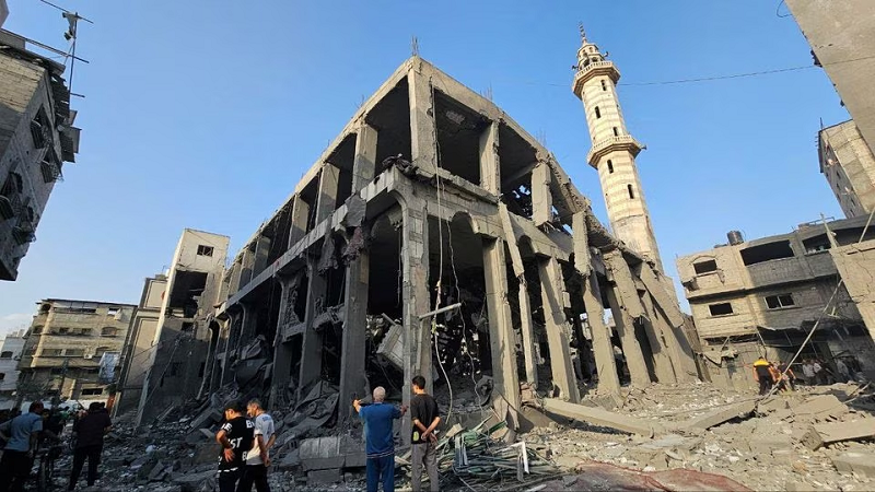 palestinians gather around the remains of a mosque destroyed in israeli strikes in the northern gaza strip october 22 2023 photo reuters