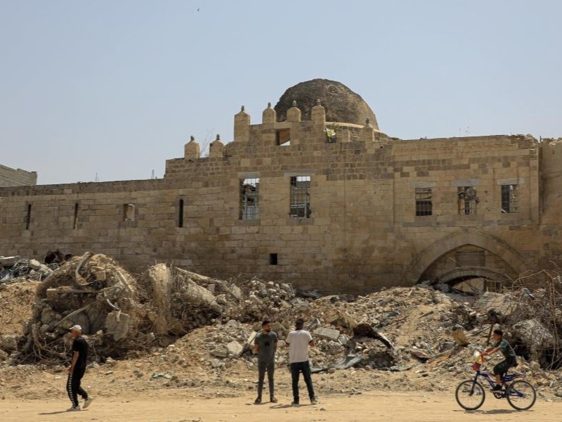 People are seen in front of the historical site of Barquq Castle destroyed in the Gaza conflict in the southern Gaza Strip city of Khan Younis, on April 23, 2024. PHOTO: XINHUA