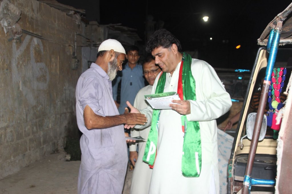 bilal ghaffar meeting people distributing hand bills to residents of sherpao basti near dhoraji photo twitter pti khi